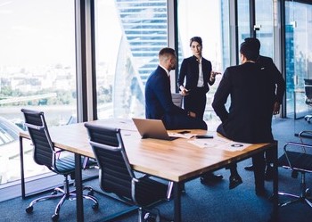 diverse-corporate-professionals-discussing-business-260nw-1702341424